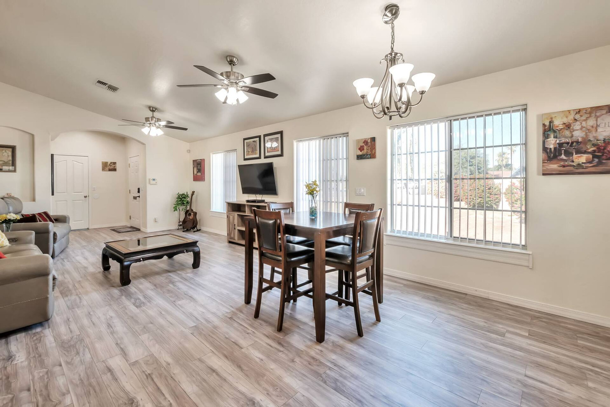 Morning coffee tastes better here — a light-filled dining area with big windows on the neighborhood