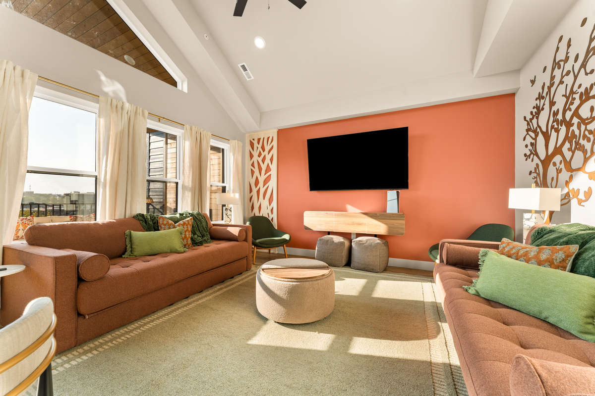 Living room: Bright, inviting living room with vaulted ceilings, comfortable seating, and a large Smart TV.