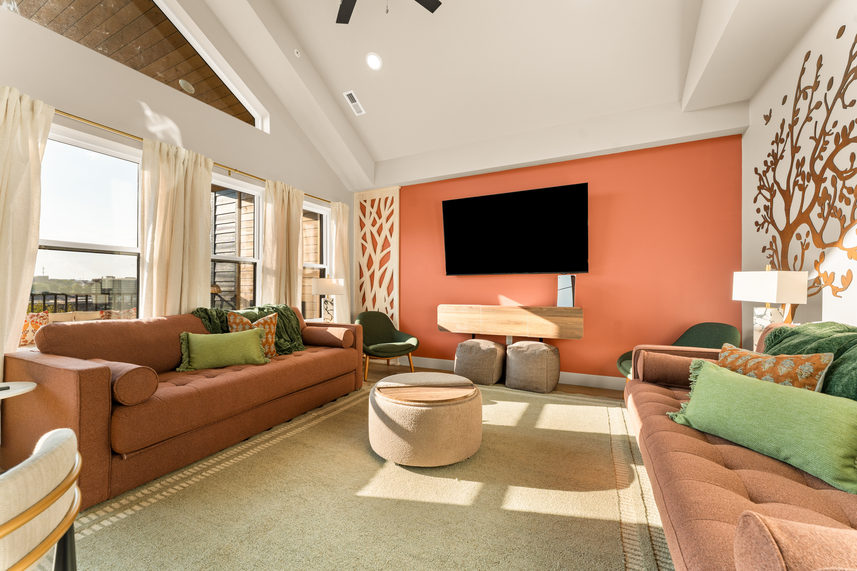 Living room: Bright, inviting living room with vaulted ceilings, comfortable seating, and a large Smart TV.