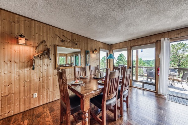 Gather around the spacious wooden dining table with seating for six, perfect for enjoying meals and making memories in a cozy, inviting space