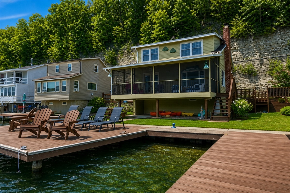 Nestled at the edge of a serene lake, this charming dock features a row of inviting, comfortable chairs, perfect for relaxing and enjoying the peaceful surroundings. The chairs, crafted from weather-resistant materials, are designed for comfort with 