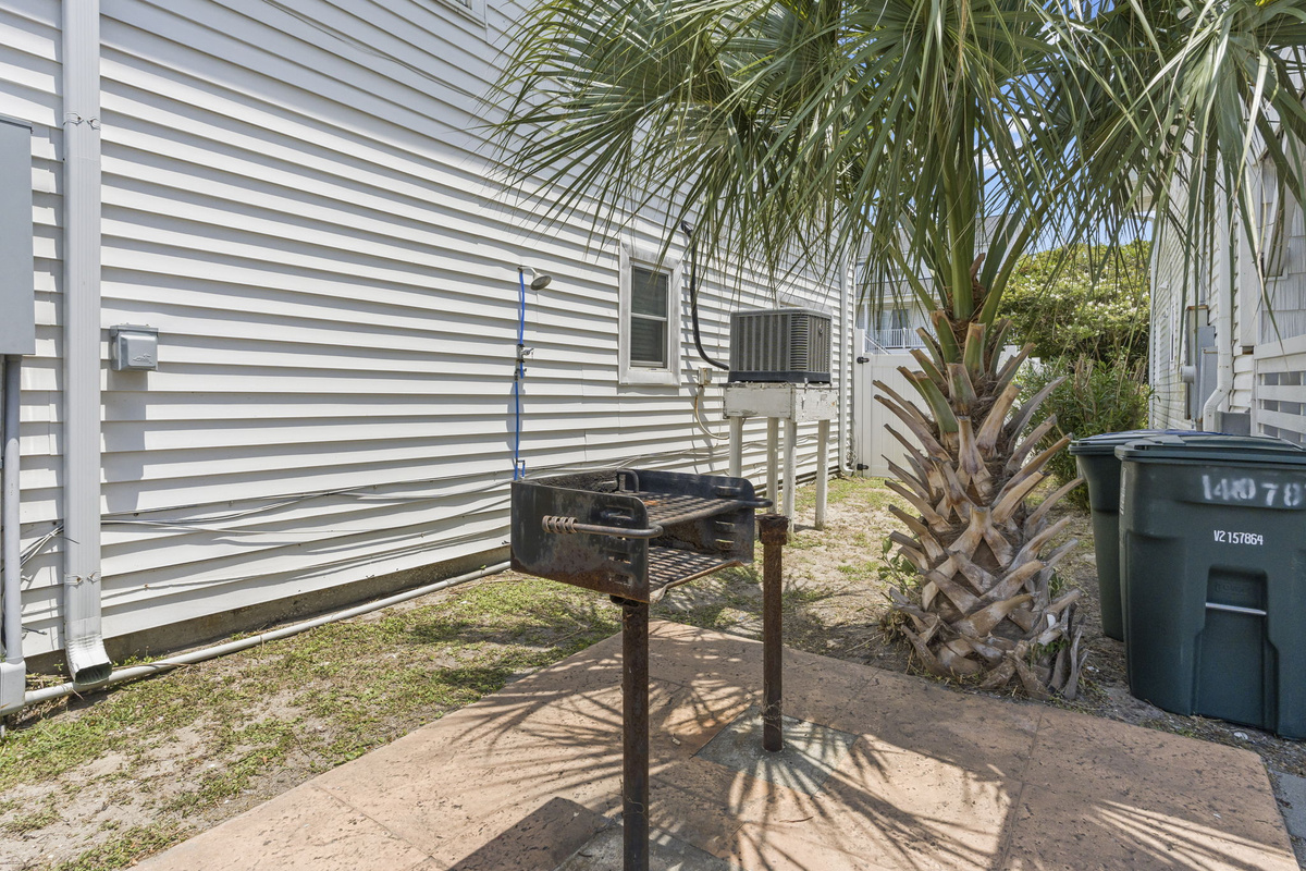 A small grill on the side yard for cooking outside