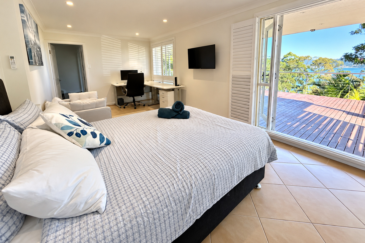 Rest comfortably in this bright and generously sized bedroom, complete with a queen bed, private sitting area and convenient work desk.
