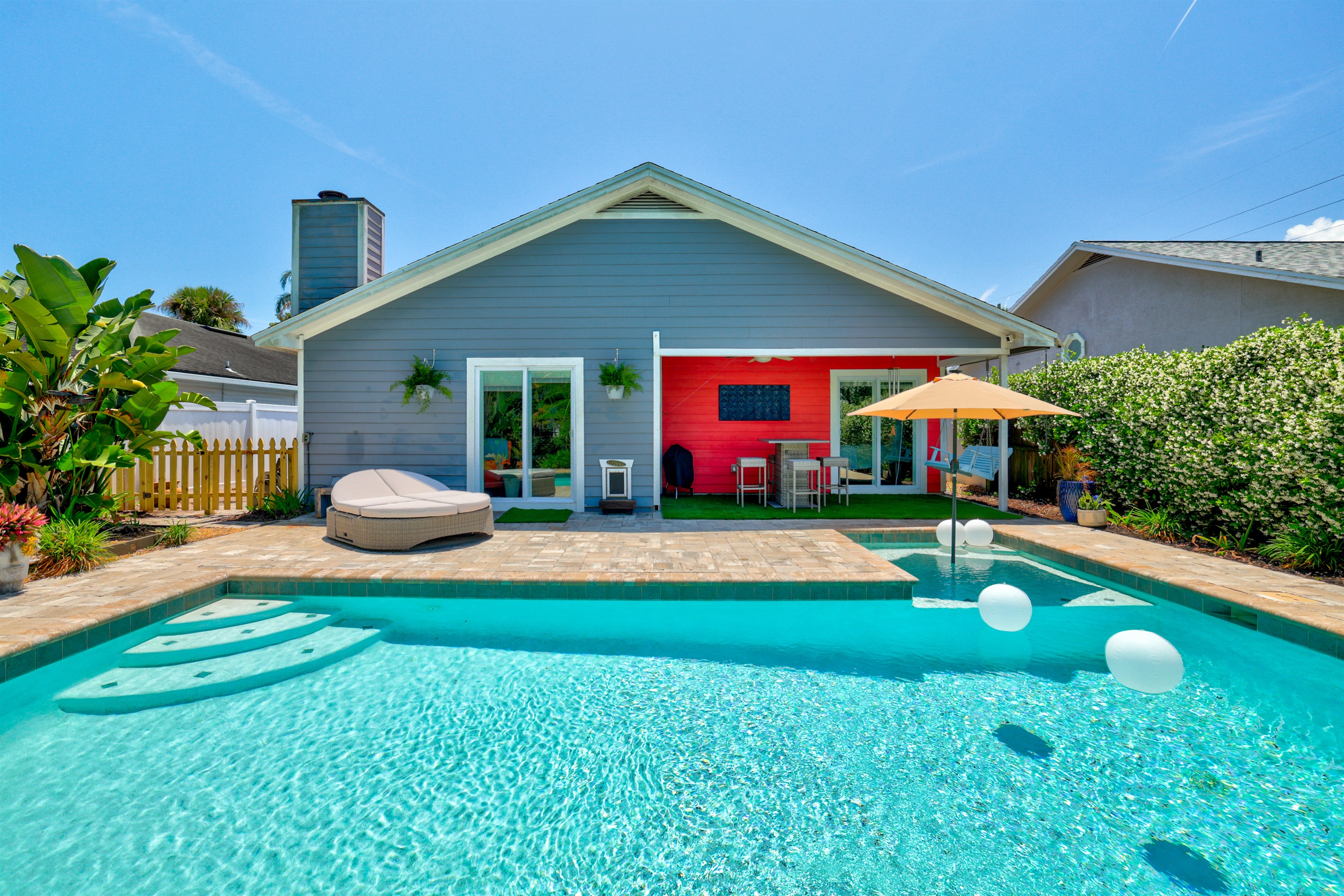 Detailed exterior shot showcasing the inviting view of the sparkling pool area from the backyard, capturing the perfect blend of relaxation and outdoor living.