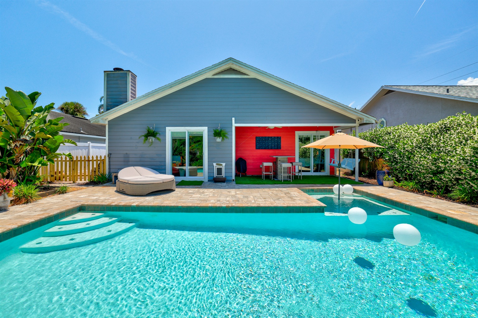 Detailed exterior shot showcasing the inviting view of the sparkling pool area from the backyard, capturing the perfect blend of relaxation and outdoor living.