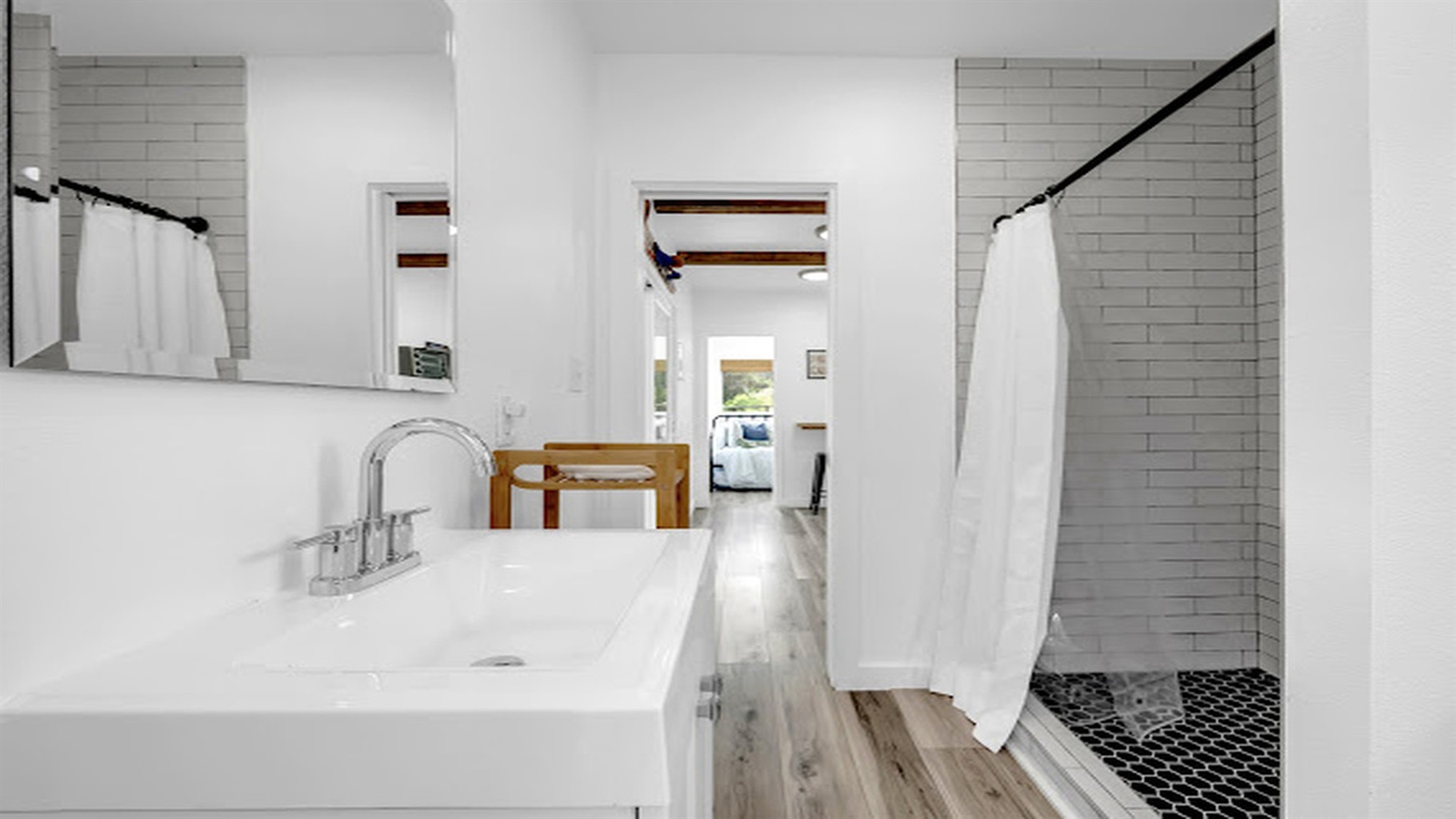 Fresh, minimalist bathroom with hotel-style comfort and plenty of light.