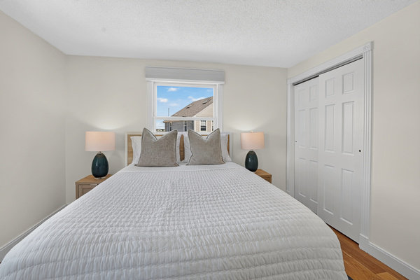 Comfortable bedroom designed for restful nights with convenient storage and bedside lighting.