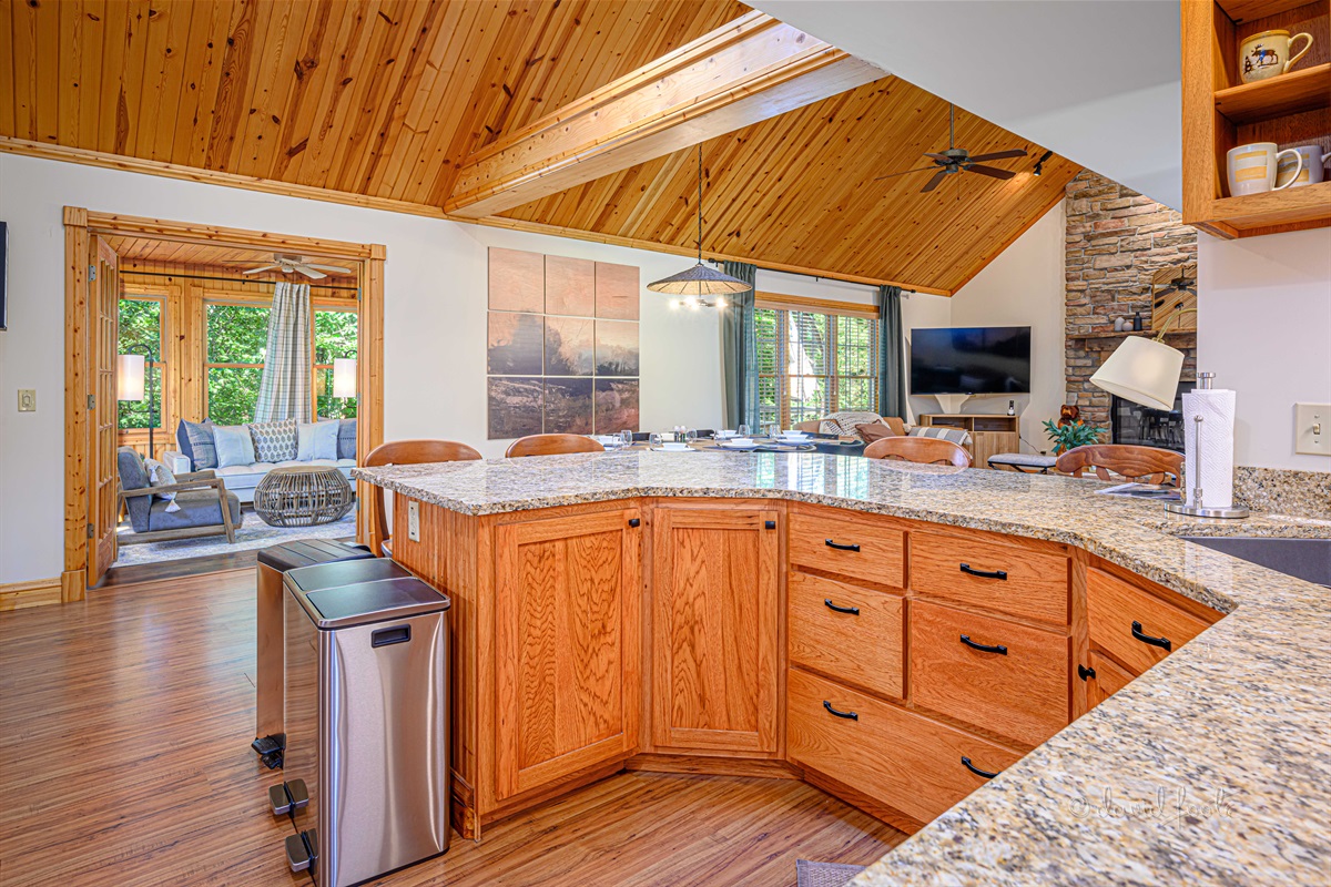 Open kitchen/dining/living room with vaulted ceiling for catching up with family and friends