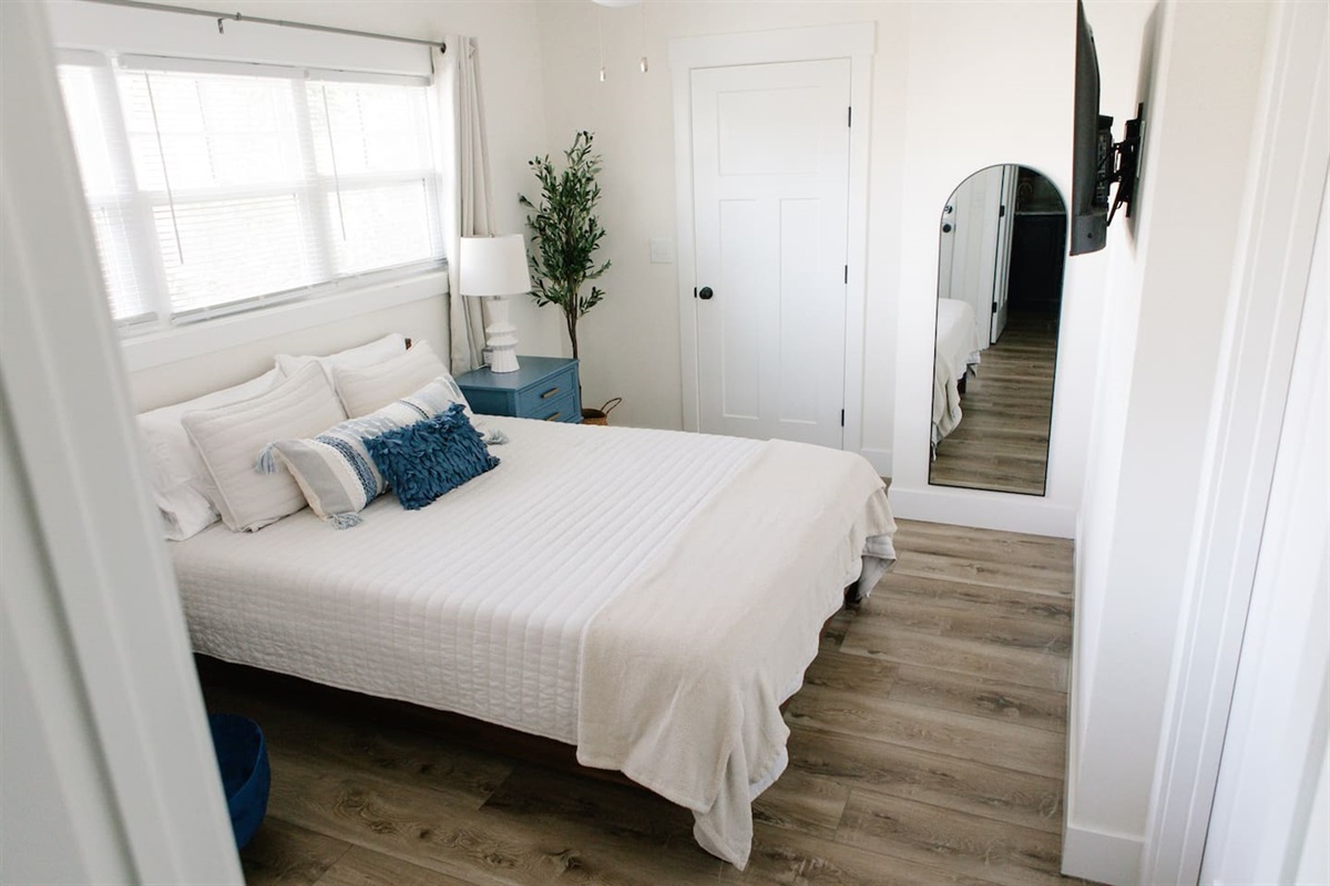 Bedroom with mirror and TV
