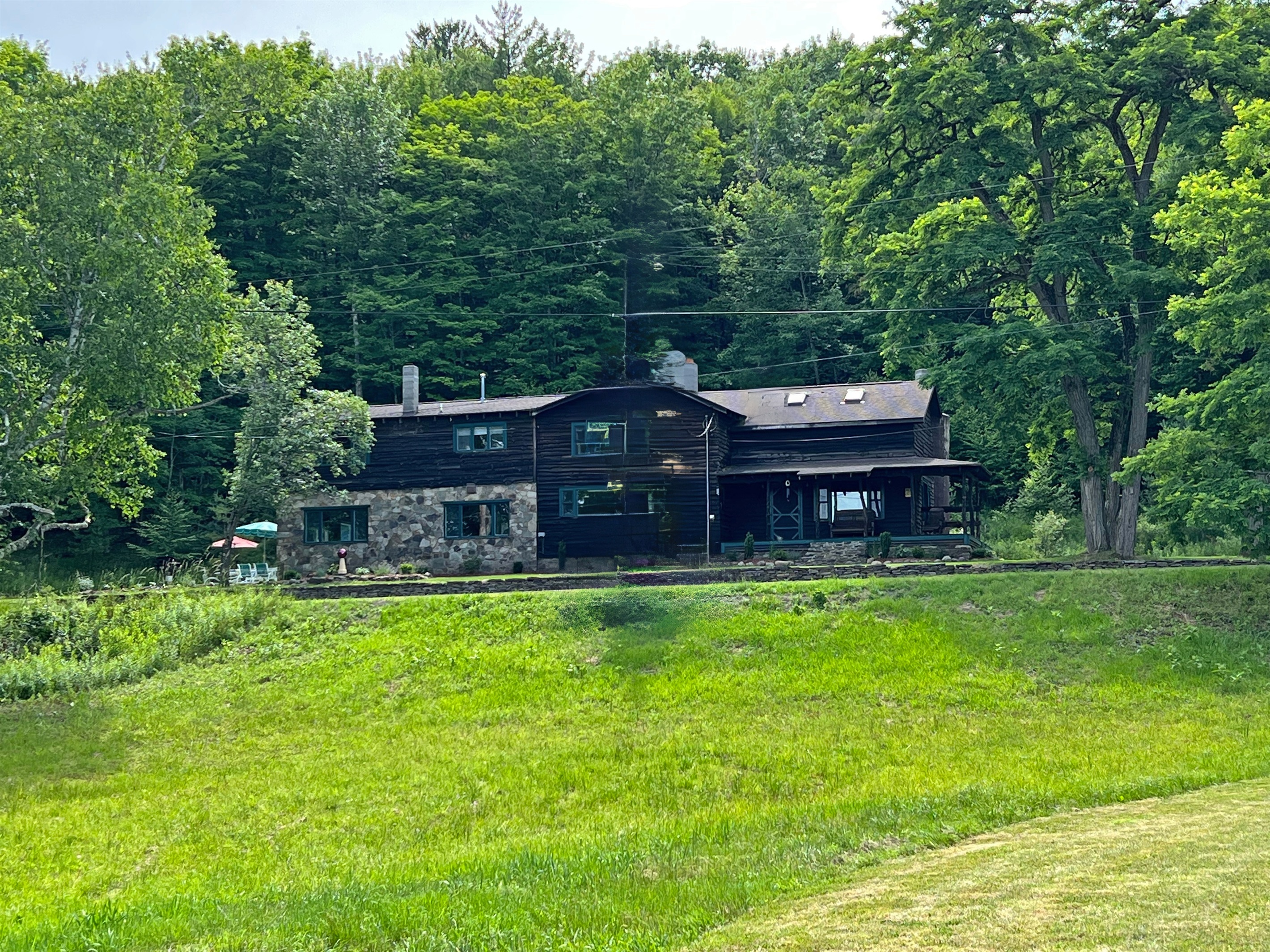The view from the pond looking up at Stolk's Lodge, the mix of stone and wood exterior is on point.