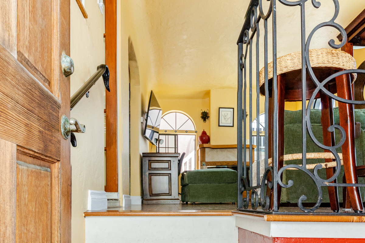 View from the front door. The apartment has a split floor plan. The living room, kitchen, dining room, bathroom and main bedroom are on the 2nd floor. The 2nd bedroom is down a flight of stairs on the first floor.