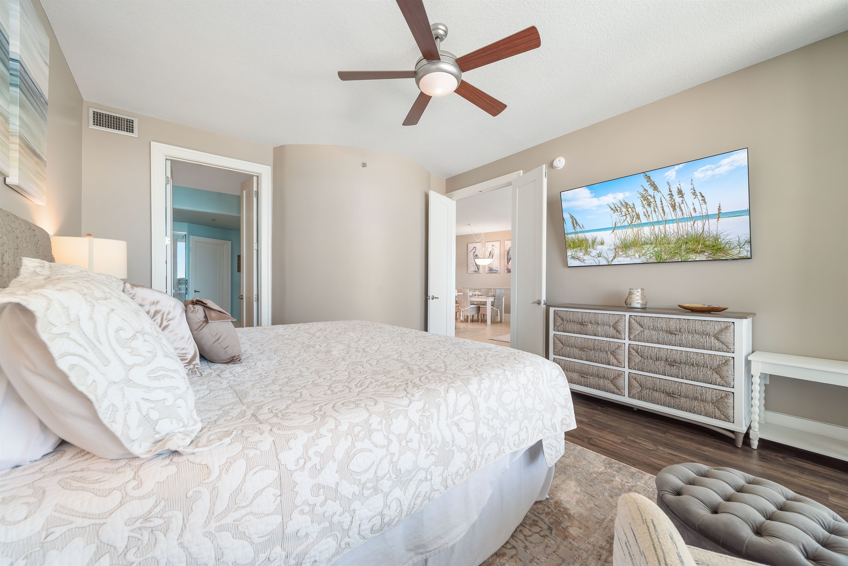 Wake up to stunning water views in this beautifully appointed primary bedroom. Seamlessly blending indoor and outdoor living, the expansive sliding doors open to a private balcony, creating a serene and luxurious retreat.