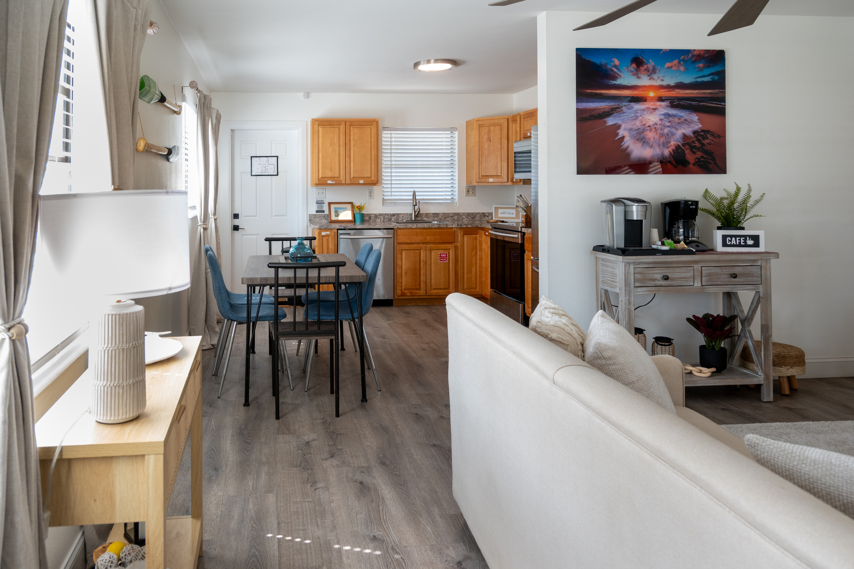 Open living space with sofas, dining table and full kitchen – minutes from the sand
