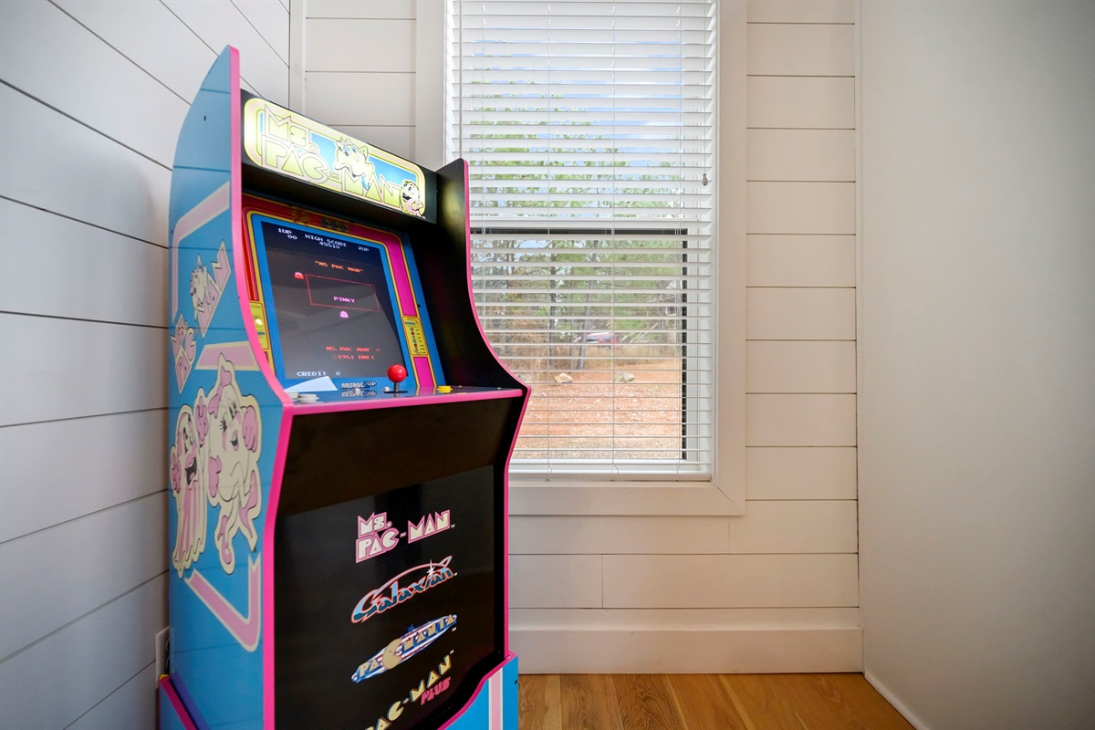 Classic arcade game tucked into the living space for relaxed, unplugged fun.