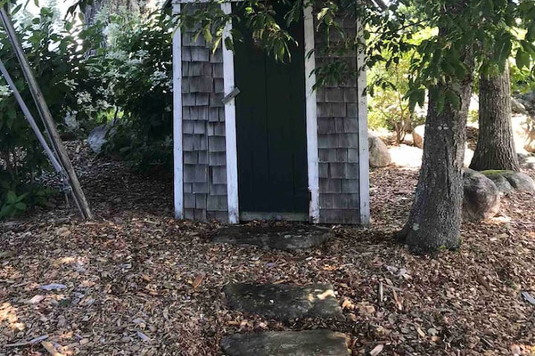 Old outhouse covering the meter box 