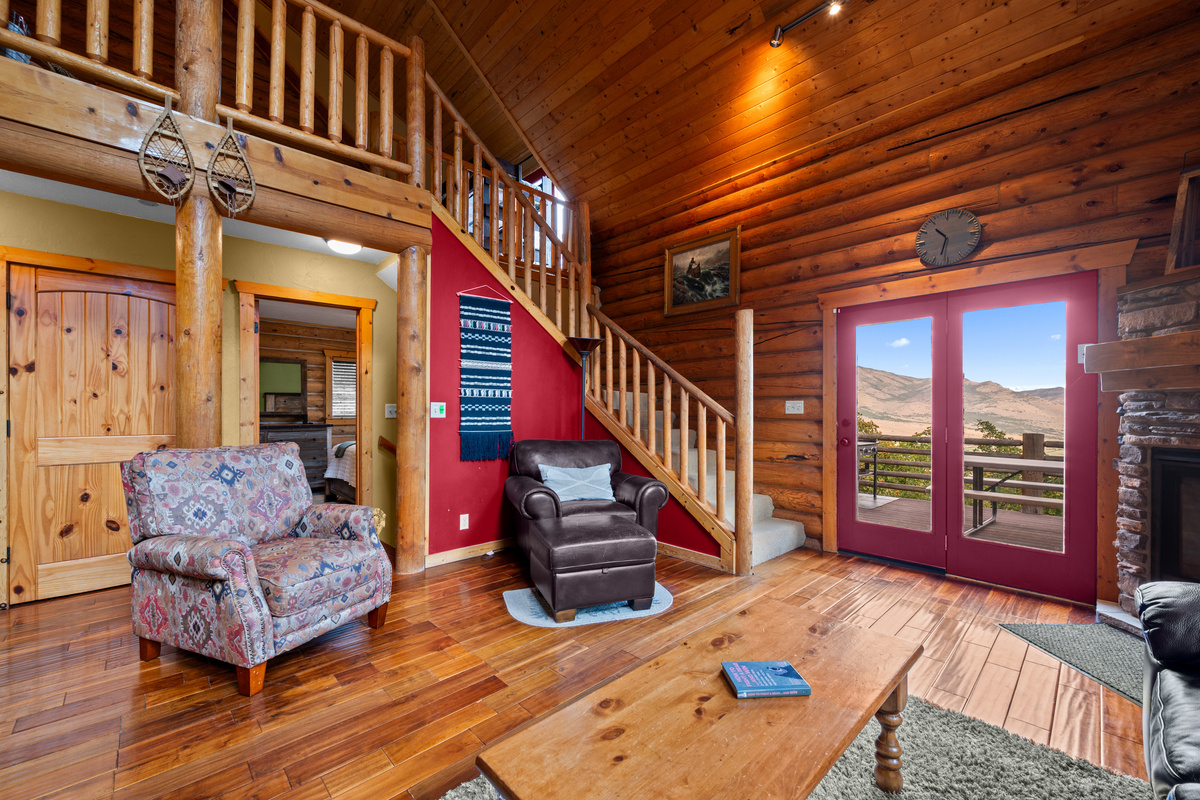 Open-concept living area with direct access to the wraparound deck and outdoor views.