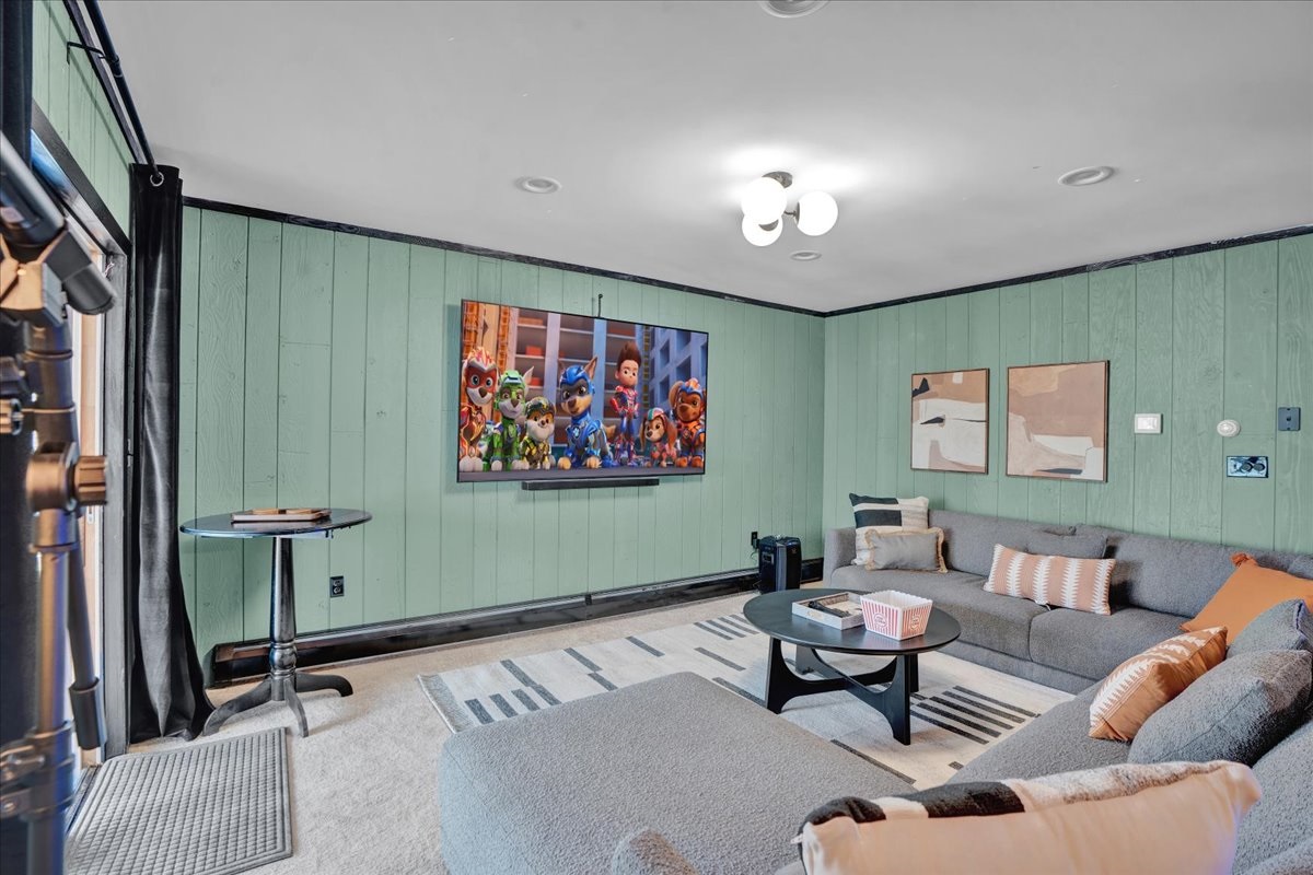 “Family-friendly lounge with retro arcade games and cozy movie seating.”