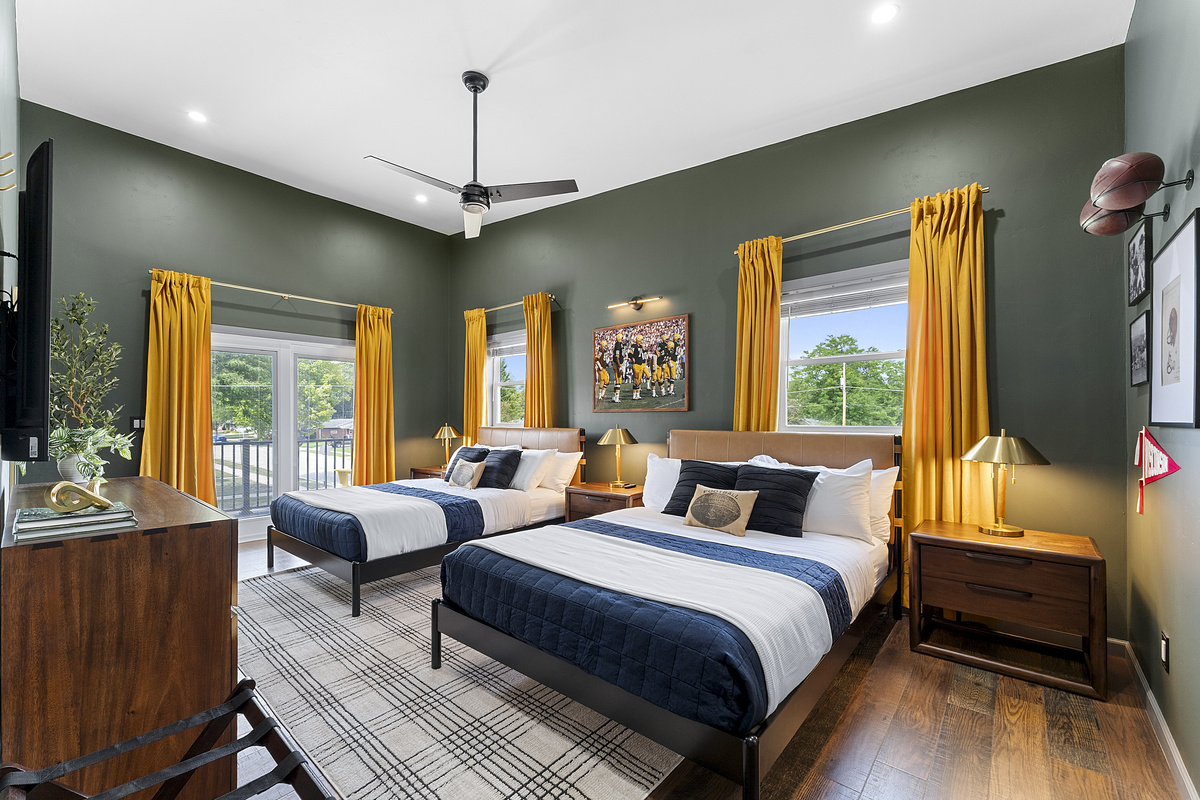 Spacious bedroom with two queen beds, ideal for families and groups.