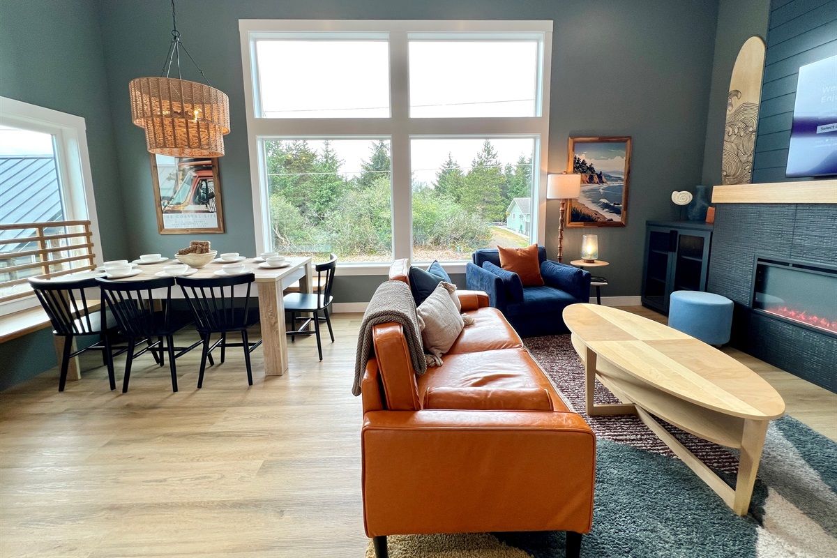 Two combined villas means there's lots of opportunities to bring people together. This is also an upstairs living and dining area — leather sofa, natural light, and a pace that slows you down.