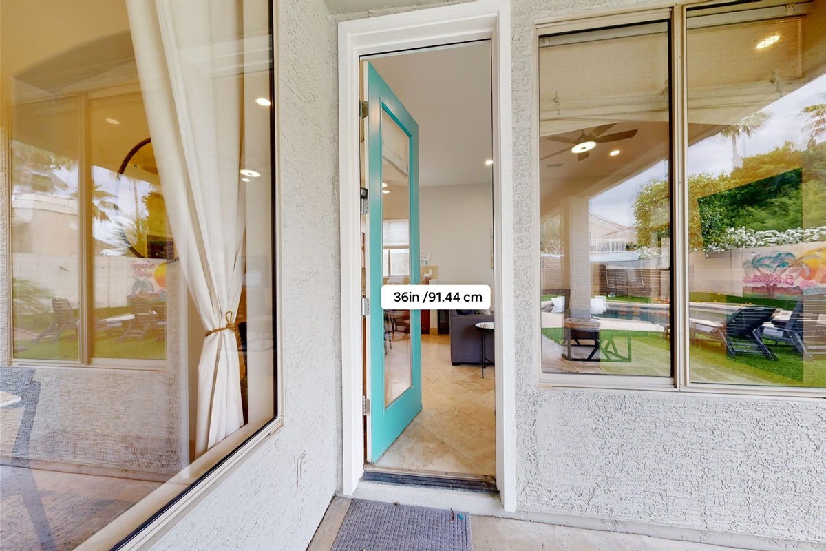 The door leading out to the backyard from the kitchen is 36 in wide and has a step to get in or out of the house.