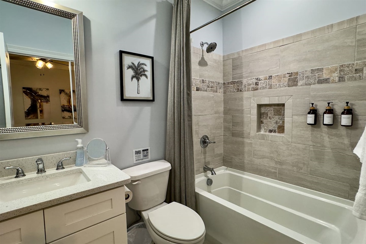 Bright bathroom with a tub/shower combo, modern finishes, and a clean, refreshing design.