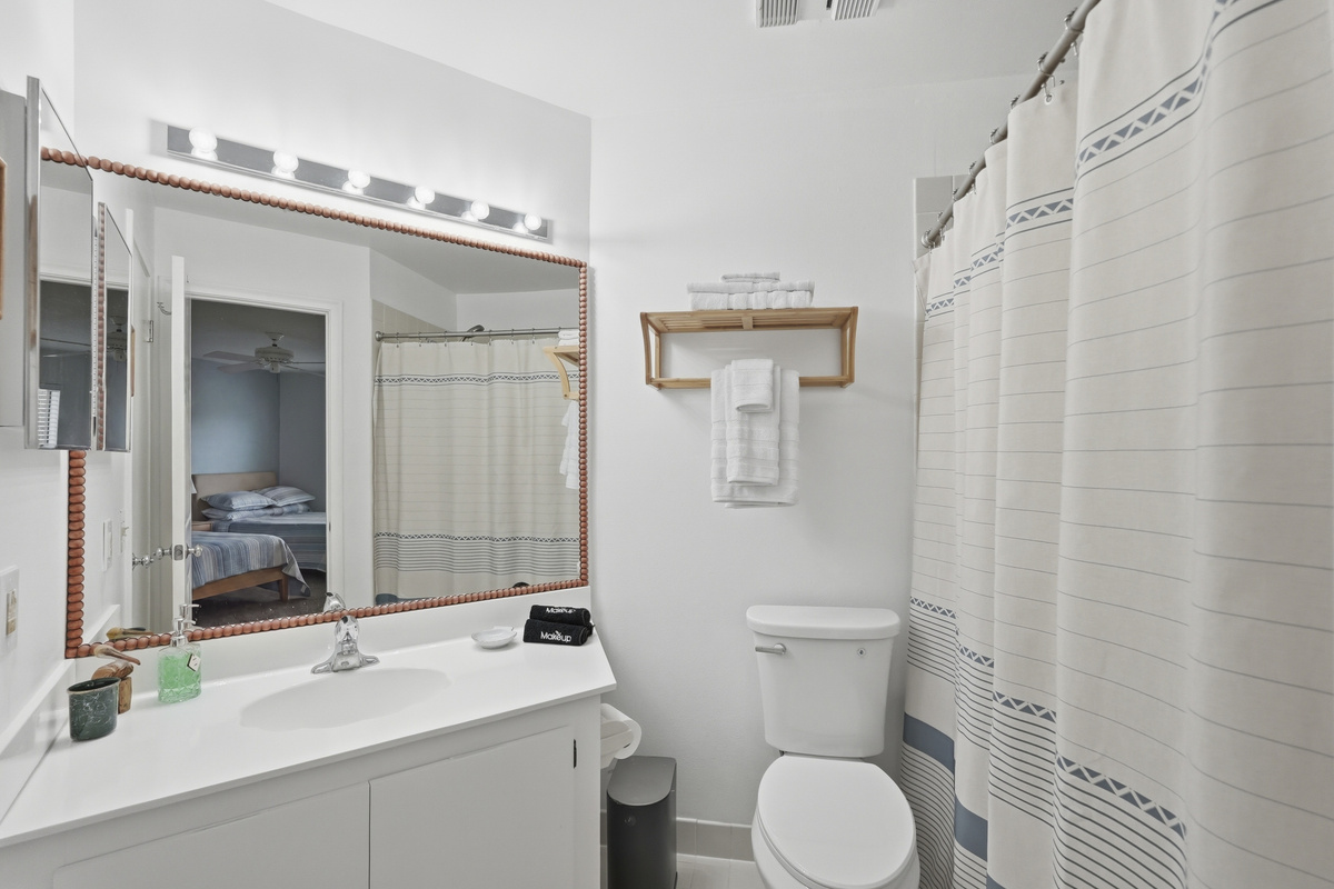 Conveniently connected to the guest bedroom, the second full bathroom offers privacy and ease for guests, with everything needed to get ready for the day or freshen up after a day at the beach.