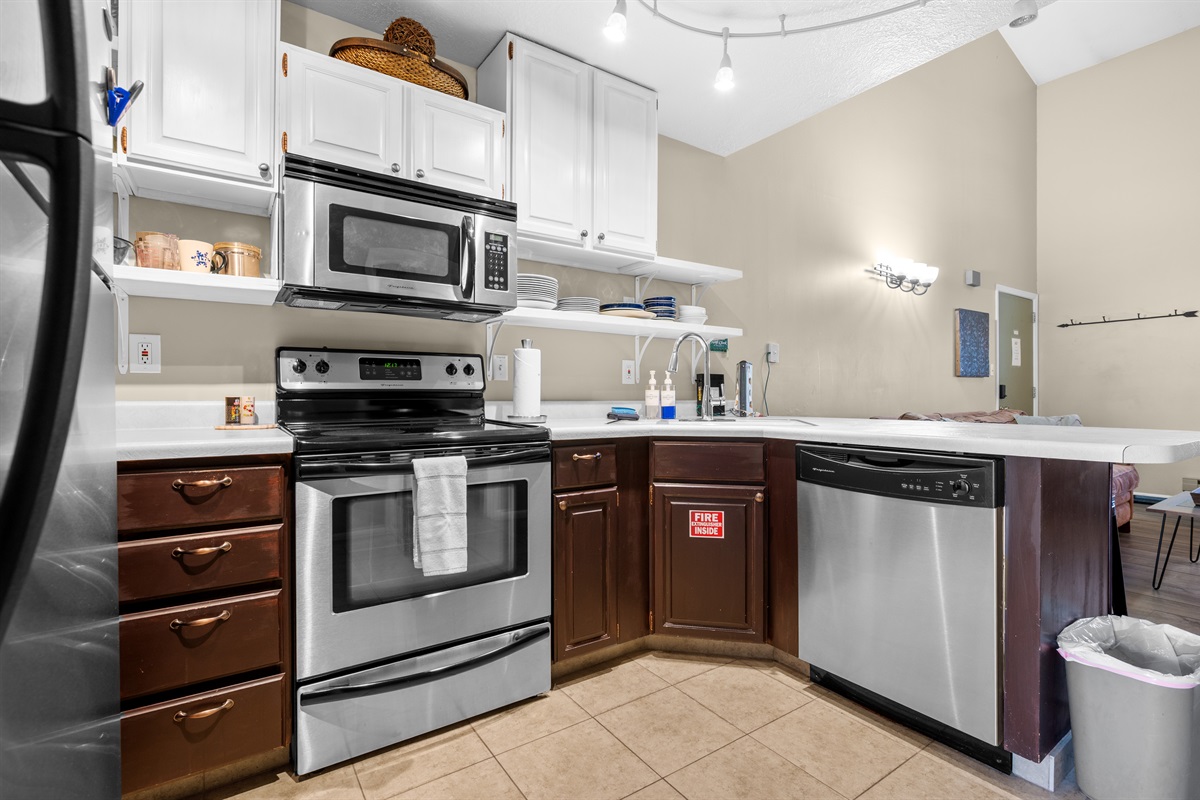 Modern kitchen with microwave, dishwasher, and plenty of counter space for cooking and entertaining.