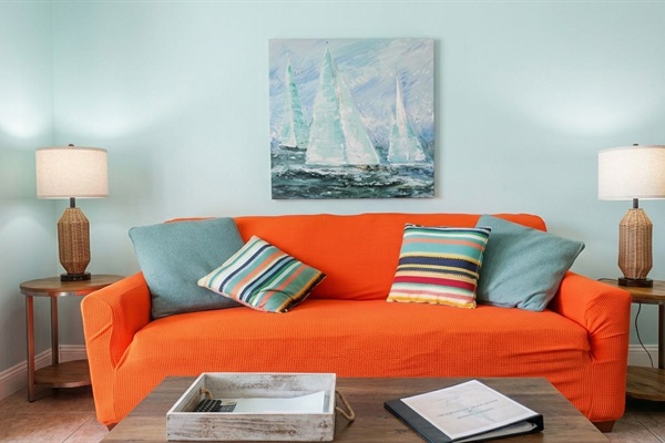 A Fresh Update: We’ve recently added this textured orange cover to our living room sofa. While we wait for our new professional photos, we wanted you to see exactly how the space looks today—bright, clean, and ready for your stay.