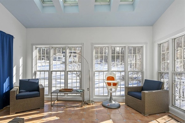 This bright and inviting sunroom offers a peaceful space for morning coffee, reading, or relaxing conversations with friends and family.
