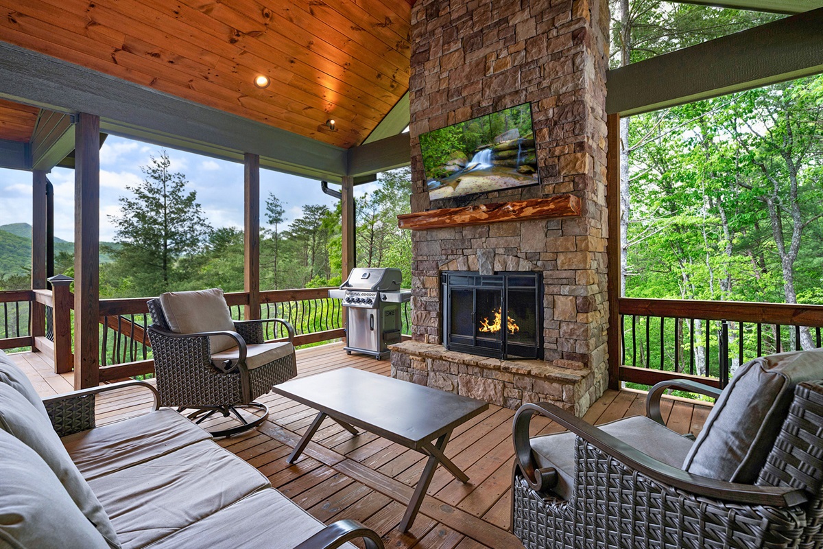 Cozy up by the outdoor fireplace on the party porch, a perfect spot for crisp evenings.