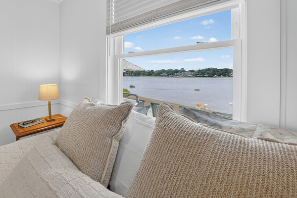Wake up to beautiful water views from the comfort of the primary bedroom.