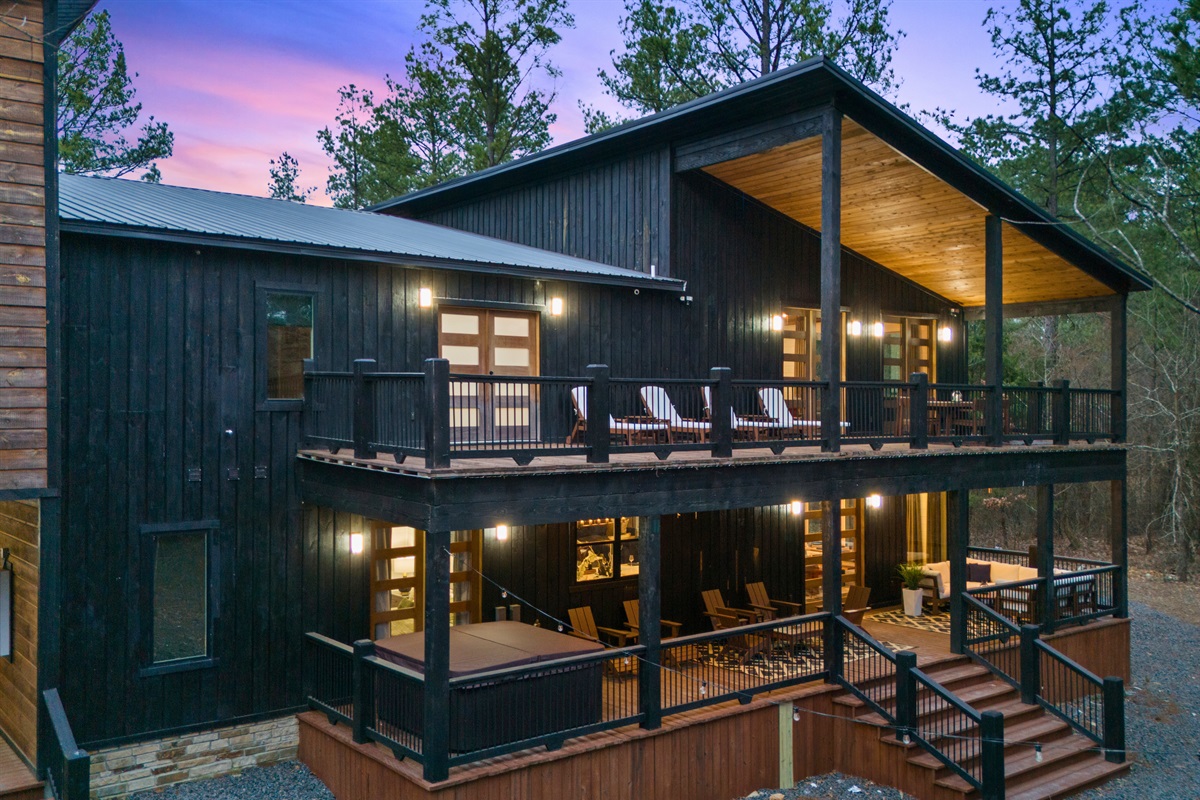 A stunning evening view of Can't Bear to Leave, with its warm glow and inviting outdoor spaces.