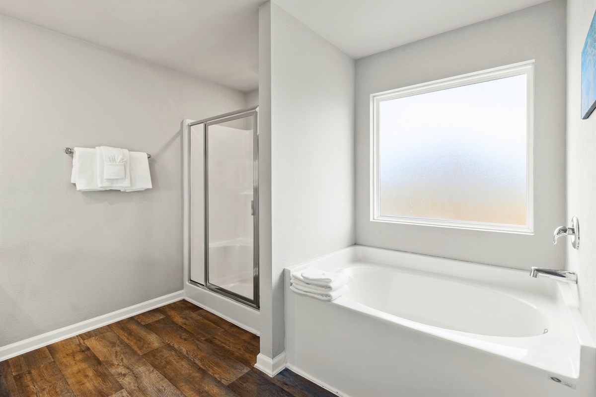 Large walk-in shower with modern finishes, perfect for rinsing off after the beach.