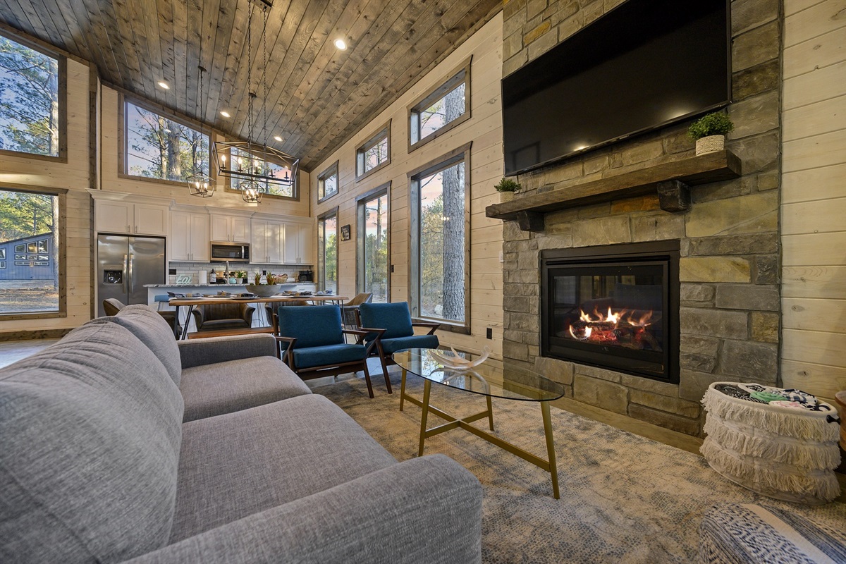 A warm hearth anchors the room with rustic stone and calm light. Curl up with a book, pour something warm, and let the evening slow to a comfortable hush.