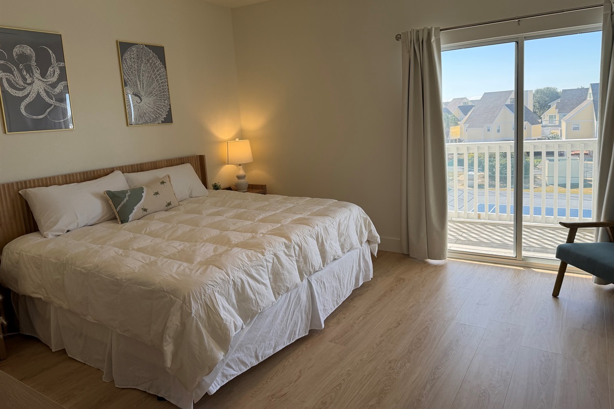 Newly renovated master bedroom with freshly painted walls and new LVP flooring!  Each nightstand has built-in charging capability for your Apple devices, with deep and roomy drawers for storage. 