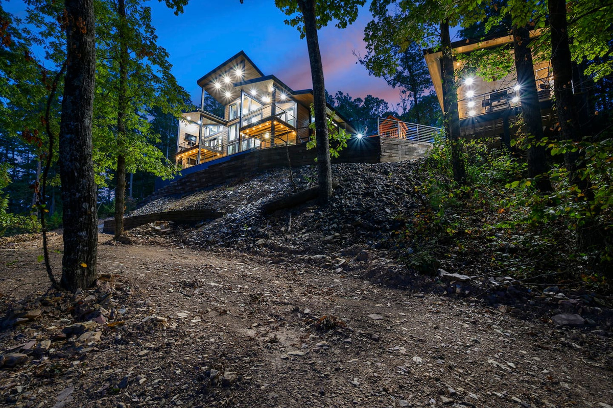 A secluded luxury retreat tucked into the Broken Bow hills, Fossil Rock offers elevated views, expansive decks, and a peaceful setting surrounded by trees.