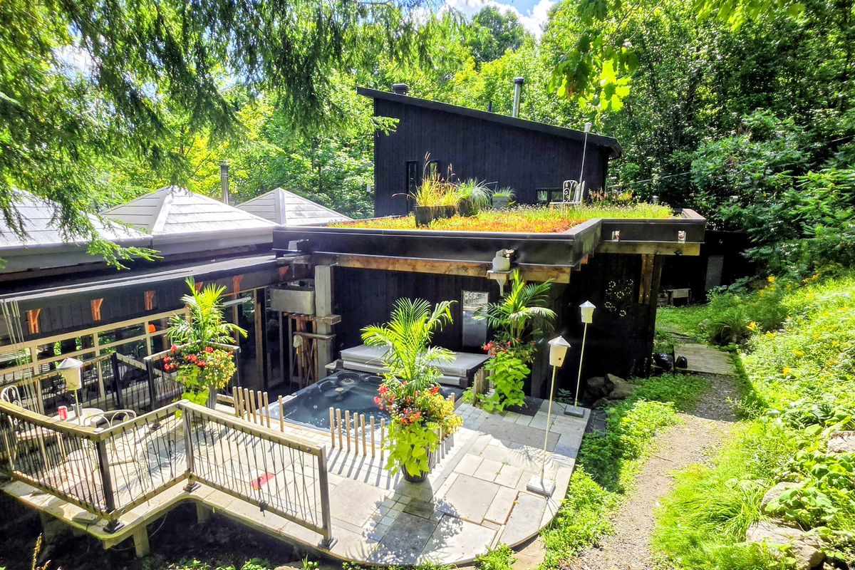 Main cottage view as you approach with hot tub and deck area
