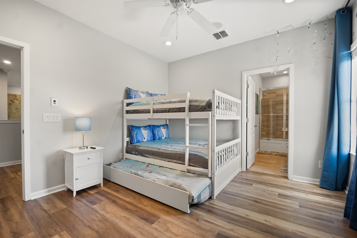 The kid's bedroom has a bunk bed with 2 full size beds and a trundle