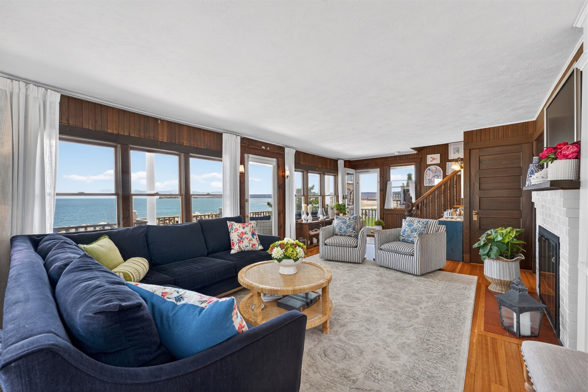 Relax in a bright, cozy living room with beautiful ocean views and coastal charm. 🌊