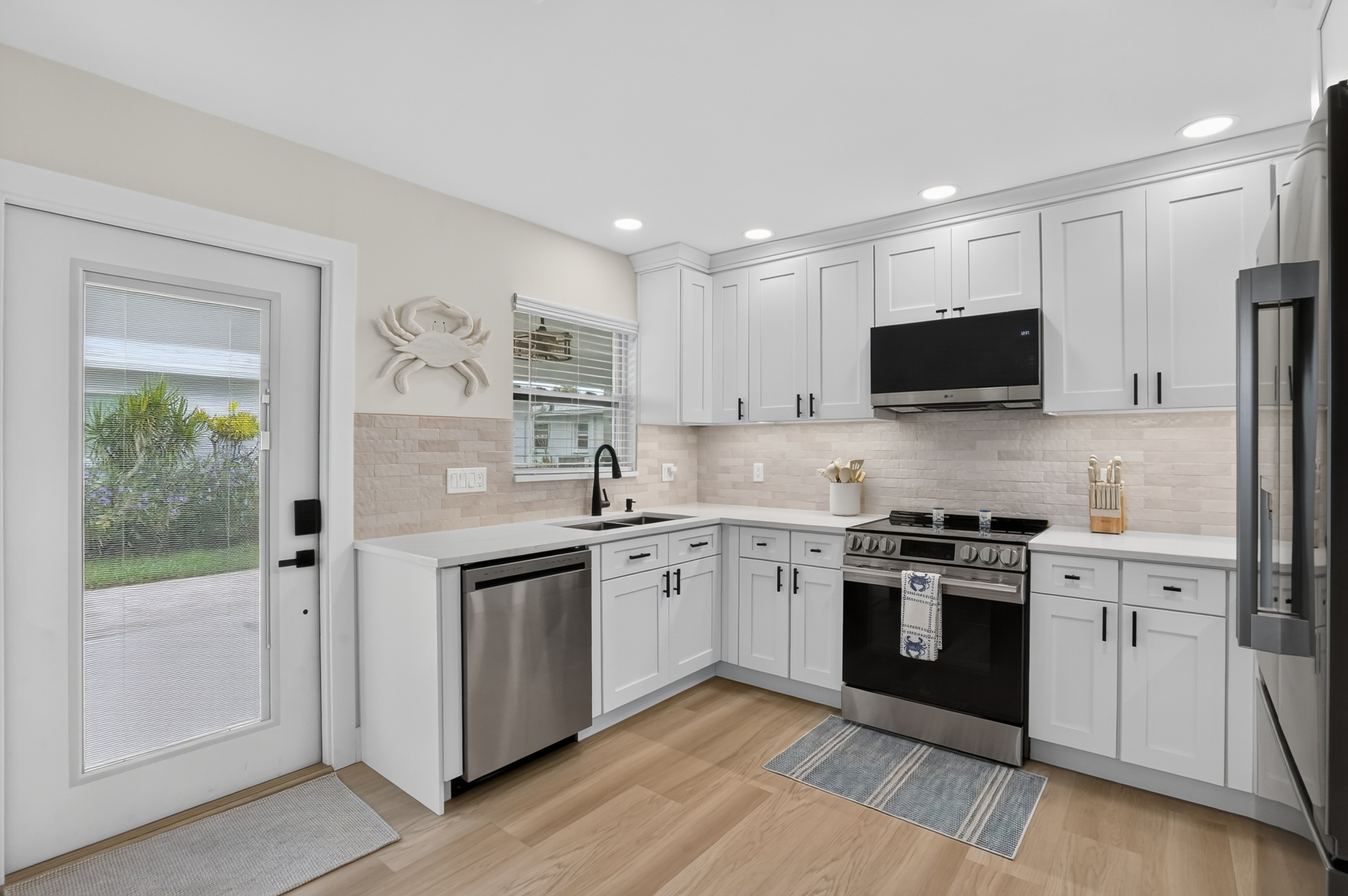 The thoughtfully designed kitchen offers modern finishes, ample storage and convenient access to the outdoor areas.
