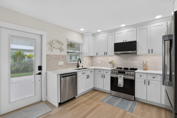 The thoughtfully designed kitchen offers modern finishes, ample storage and convenient access to the outdoor areas.
