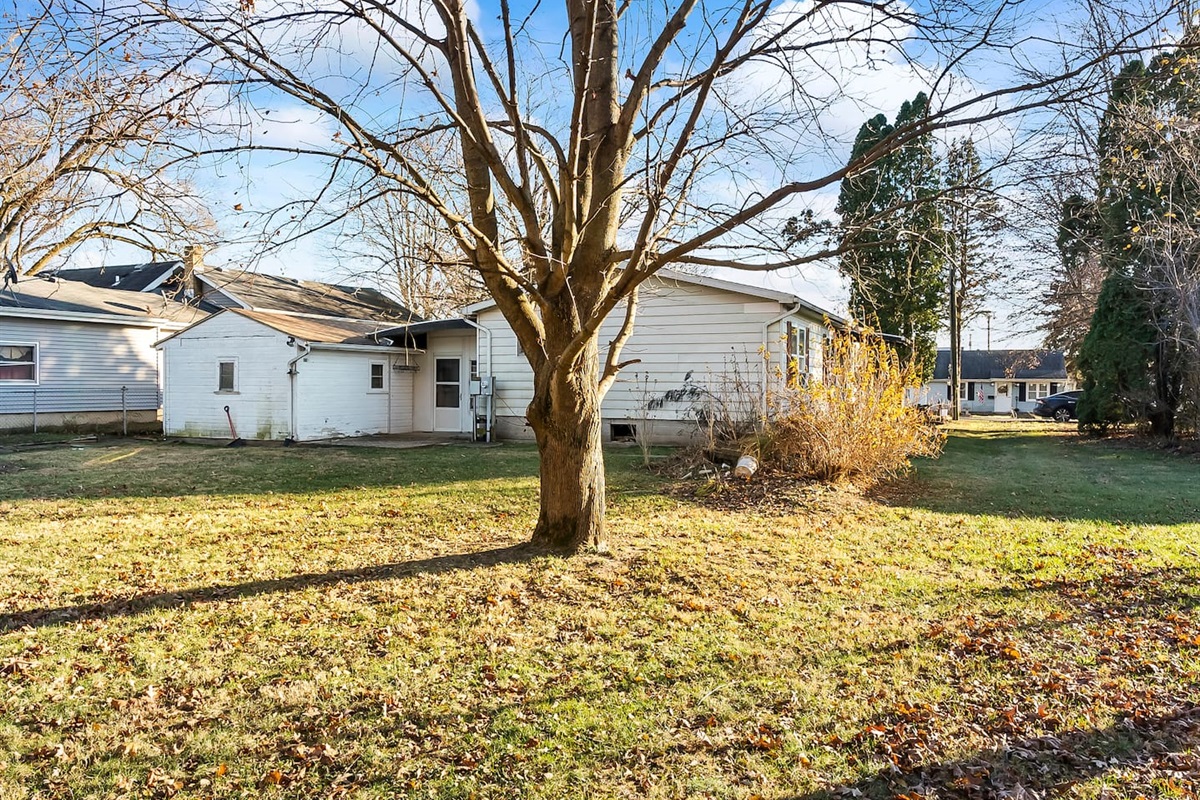 Tree-lined yard with natural landscaping and room to relax or play.
