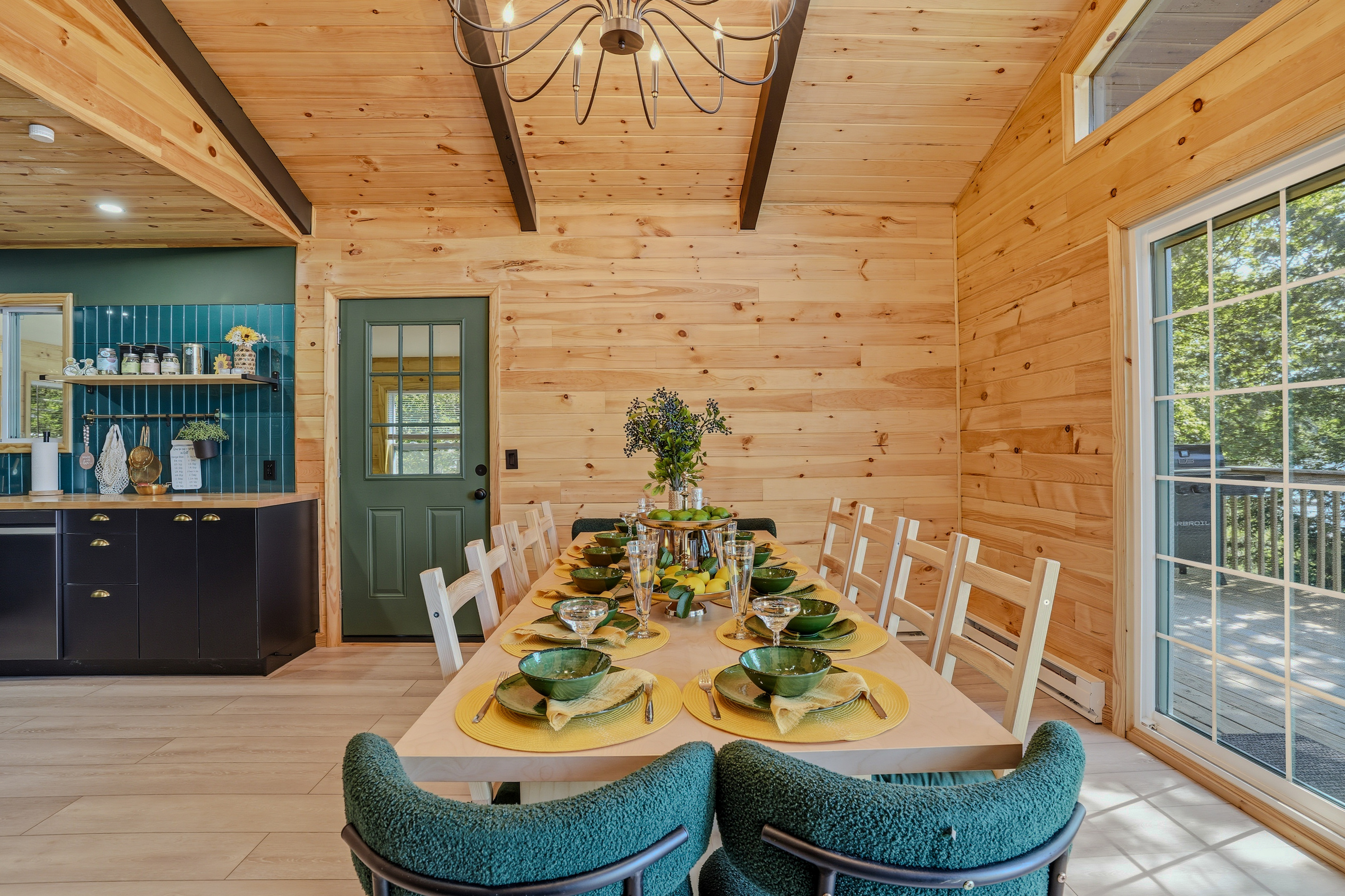 Dining room — long table set for the group with chandelier and lake-view windows