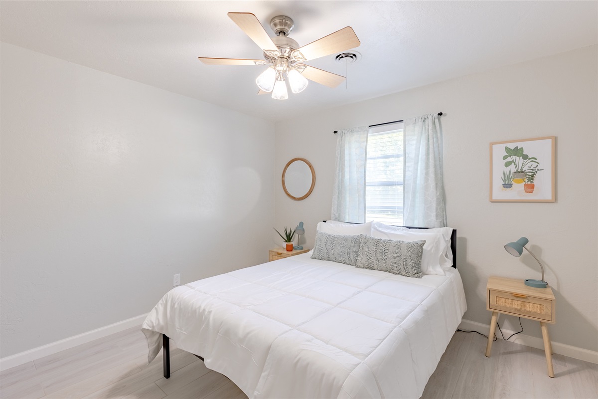 Bright and comfortable guest room with a cozy queen bed.