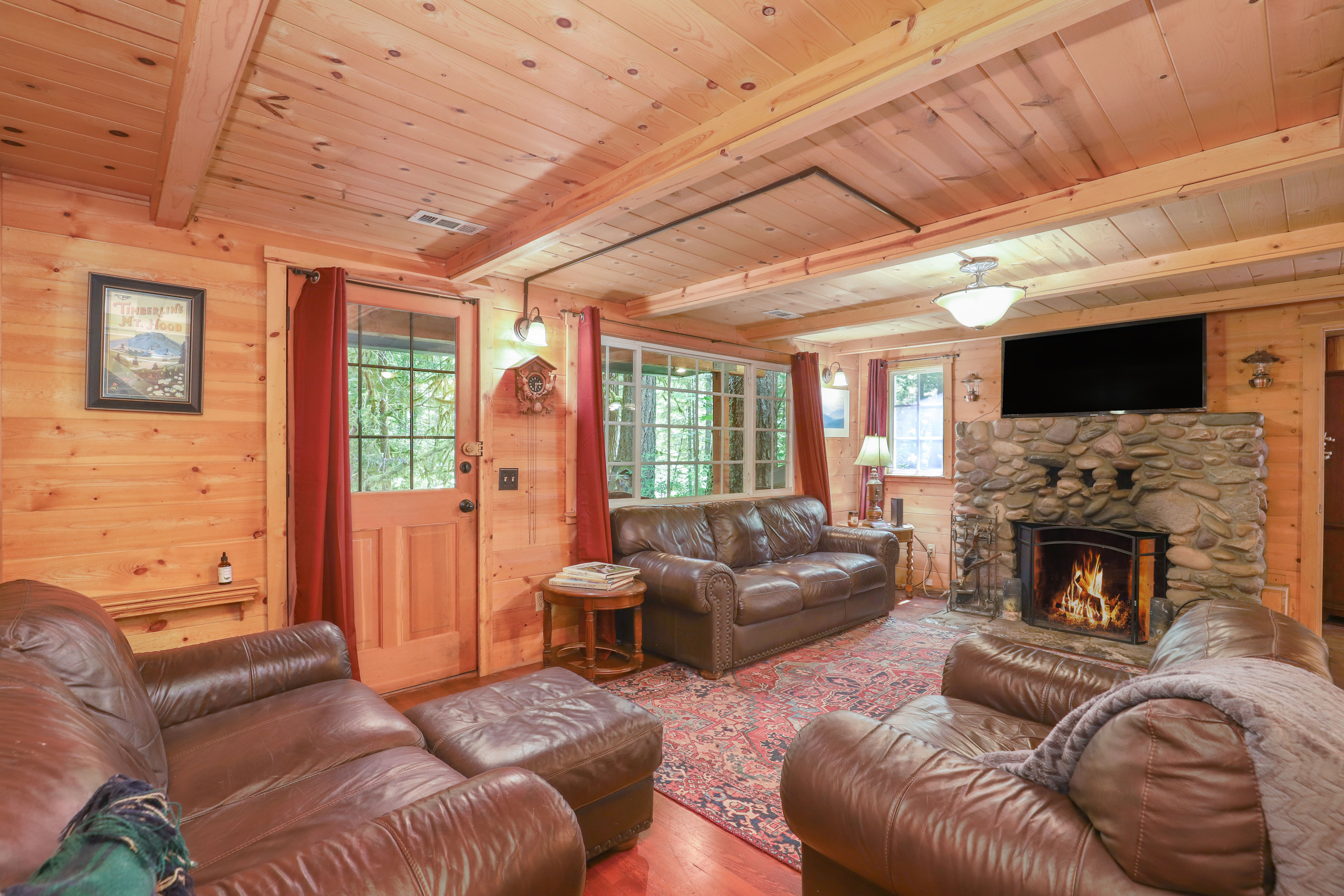Oversized Leather Chairs and a Cozy Living Room River Rock Fireplace