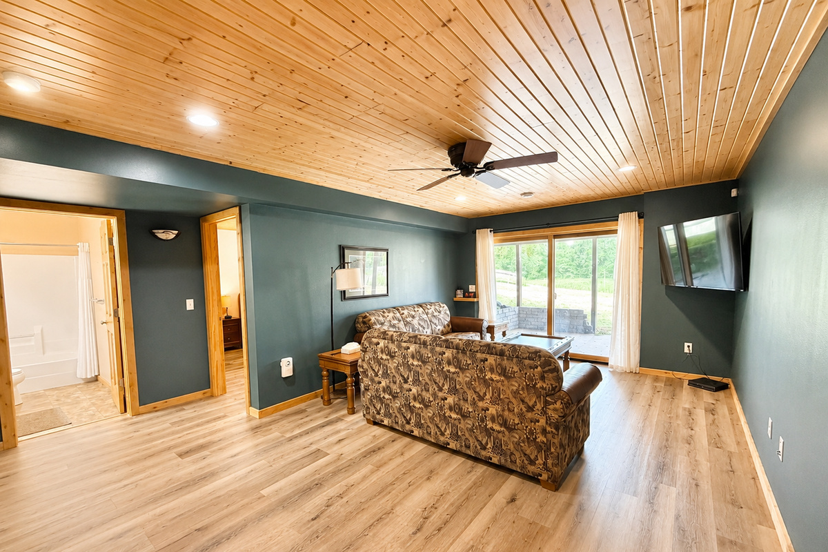 Lower level living area with a large TV and comfortable seating gives your group another place to relax and spread out.
