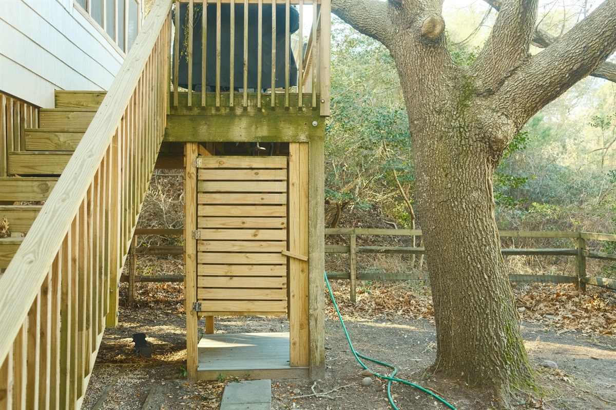 Outdoor showers, and backyard stairs to grill area / screen porch. 