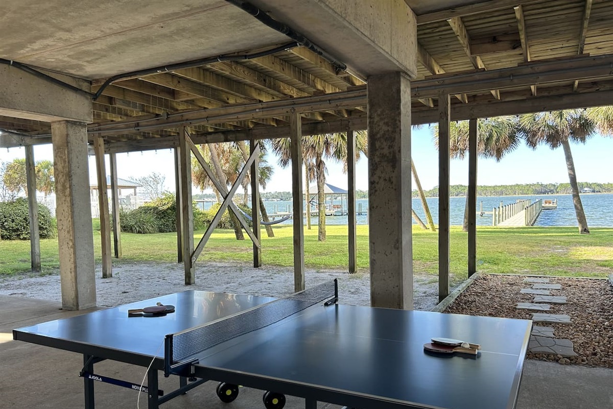 Relaxing lakeside ping pong under a shady patio with serene water views. Where else can you play ping pong with a view like this?
