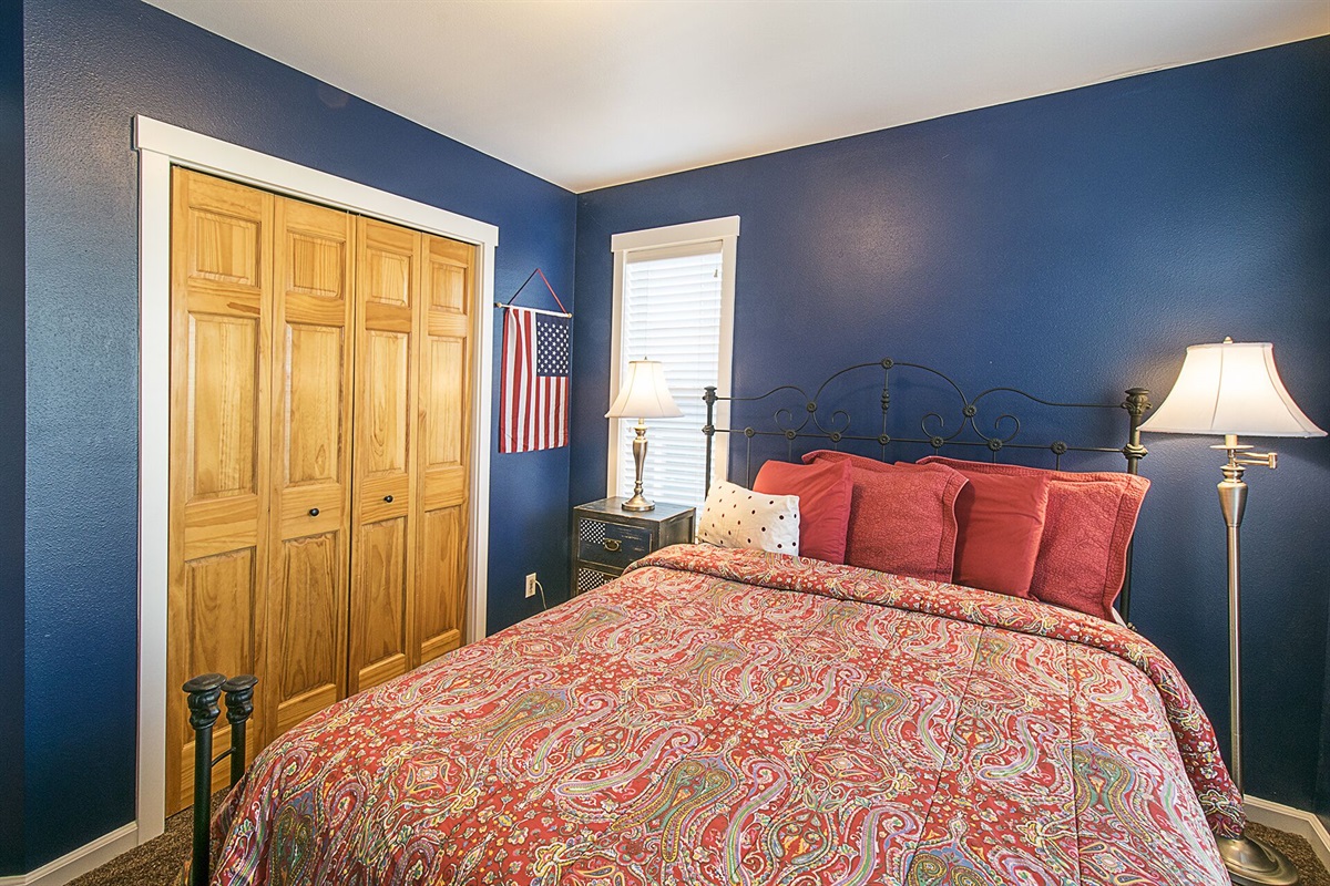 Relax in the queen room, featuring navy blue walls that capture the charm of coastal living.