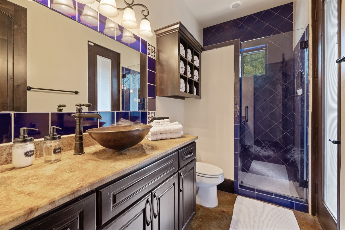 "Step into luxury in our stunning pool bath, adorned with beautiful tilework that adds a touch of elegance. It's the perfect spot to rinse off after a day of fun in the sun!"